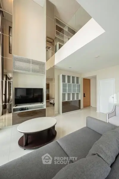 Spacious modern living room with high ceiling and sleek design
