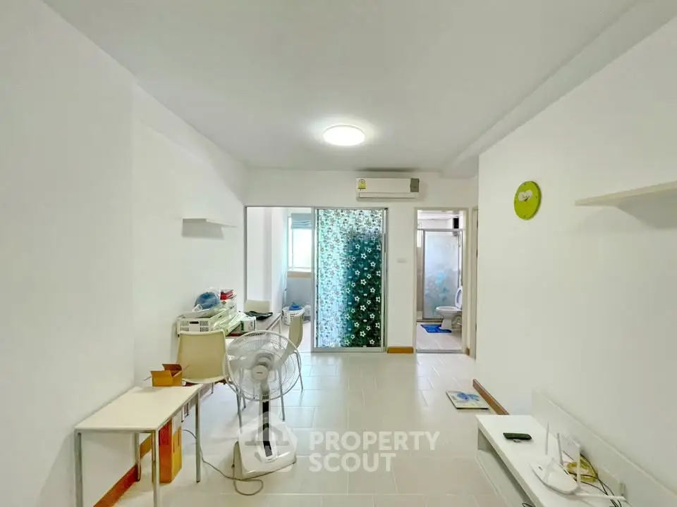 Spacious living area with modern decor and ample natural light