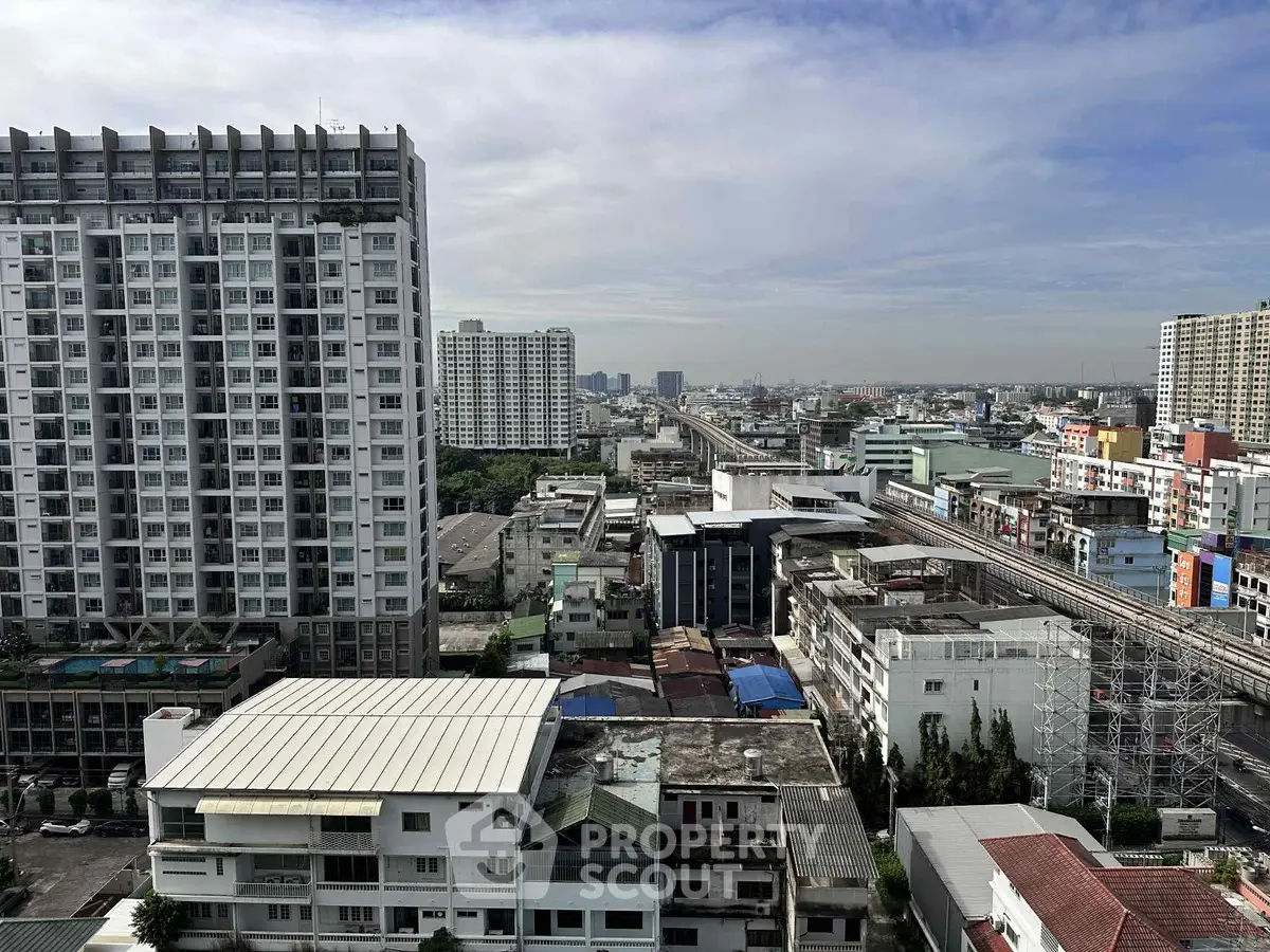 Stunning cityscape view from high-rise building showcasing urban skyline and residential architecture.