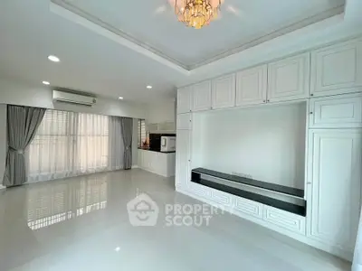 Spacious modern living room with elegant white cabinetry and large windows
