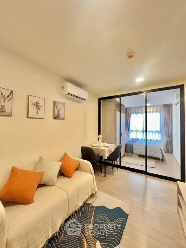 Modern living room with cozy sofa and elegant bedroom view