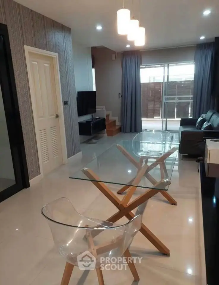 Modern living room with glass dining table and stylish decor