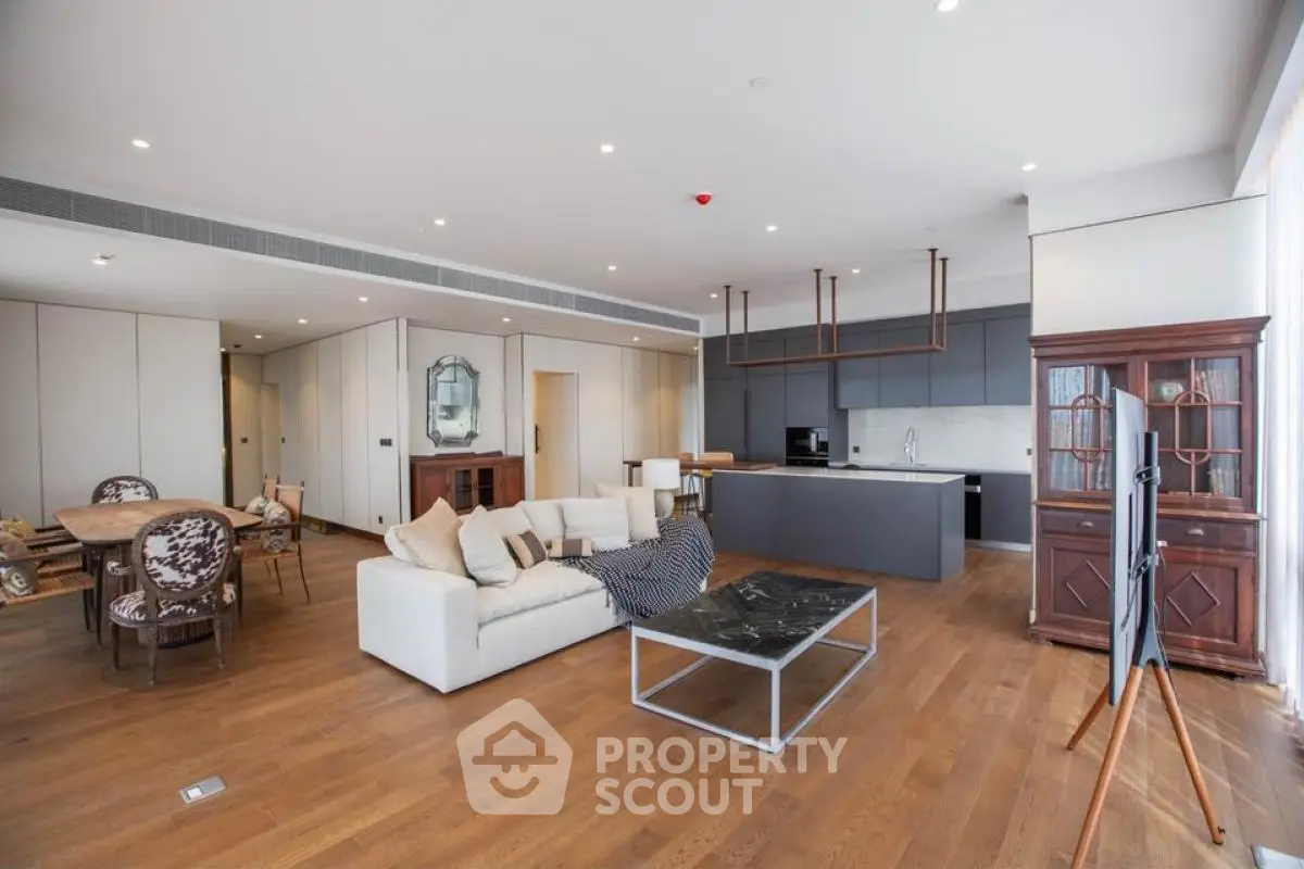 Spacious open-plan living room with modern kitchen and elegant decor.