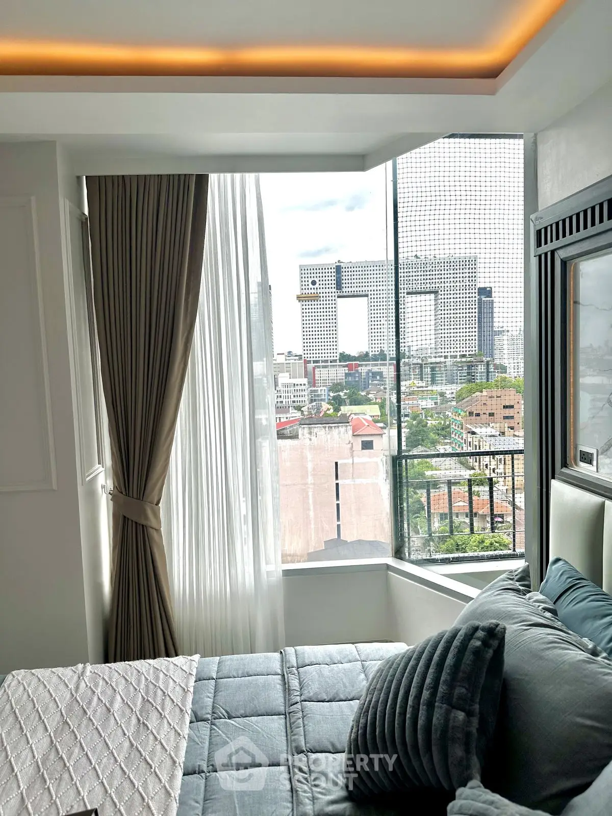 Luxurious bedroom with stunning city view and elegant decor