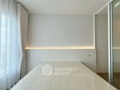 Modern minimalist bedroom with large window and sleek design