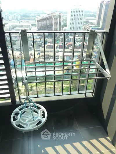 Modern balcony with city view and drying rack, perfect for urban living.