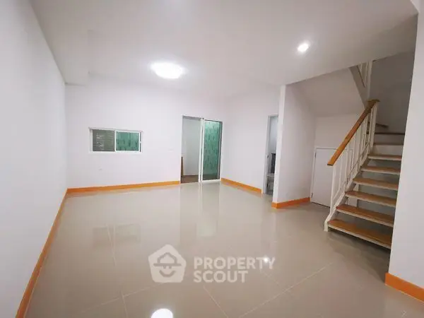 Spacious modern interior with sleek staircase and glossy tiled flooring