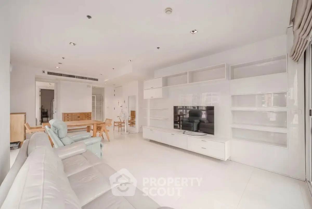 Spacious modern living room with sleek white furniture and open layout