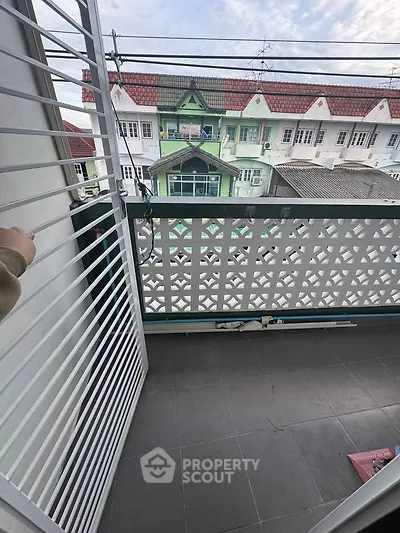 Charming balcony with decorative railing and urban view, perfect for relaxation and enjoying city life.