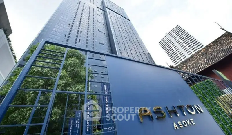 Modern high-rise building with sleek design and lush greenery at Ashton Asoke.