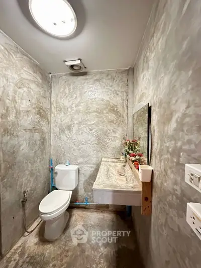 Modern minimalist bathroom with concrete walls and stylish fixtures