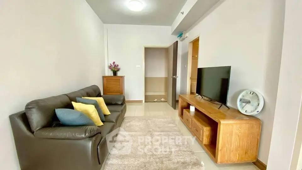 Cozy living room with modern decor and comfortable seating in a stylish apartment.