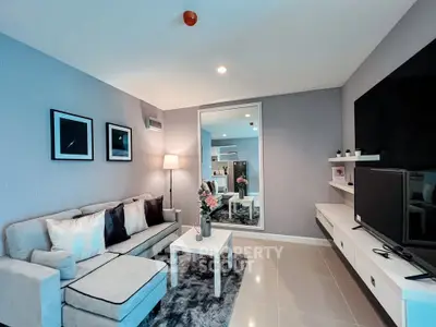 Modern living room with stylish decor and cozy seating area, perfect for relaxation and entertainment.