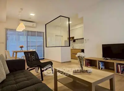 Modern open-plan living room with stylish furniture and kitchen view