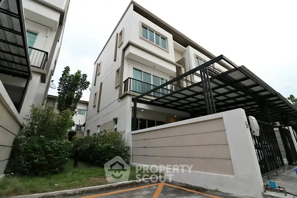 Modern townhouse with sleek design and spacious balcony in a serene neighborhood.