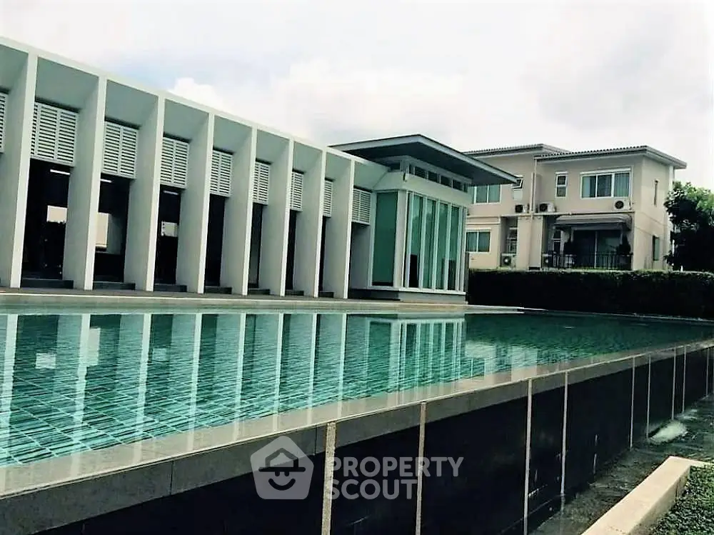 Modern architectural building with sleek pool reflecting contemporary design.