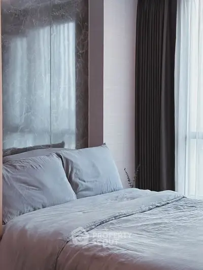 Cozy bedroom with elegant decor and large window for natural light