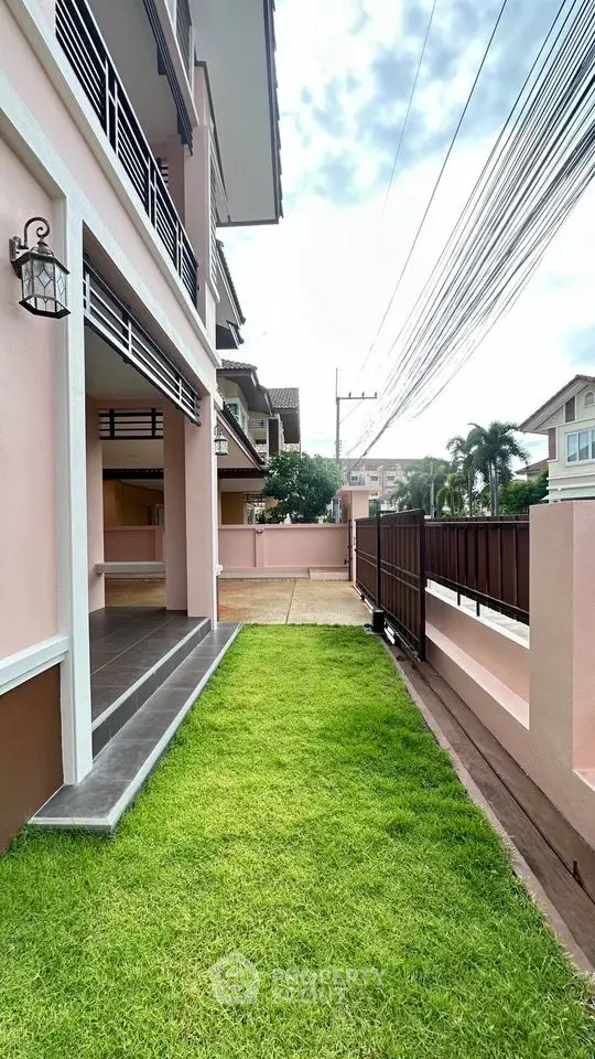 Charming suburban home with lush green lawn and modern exterior design.