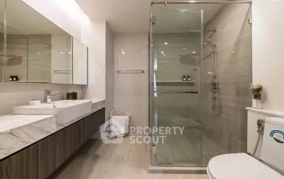 Luxurious modern bathroom with glass shower and elegant fixtures