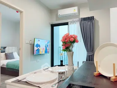 Modern apartment interior with dining area, TV, and balcony view, showcasing stylish decor and cozy ambiance.