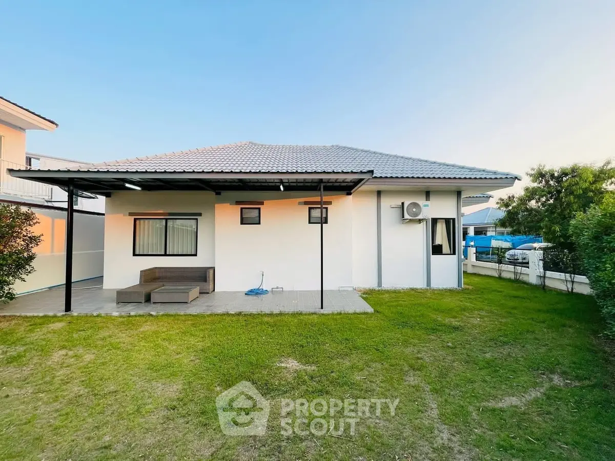 Charming single-story home with spacious backyard and modern exterior design.