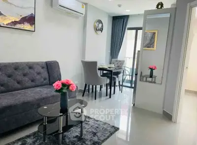 Modern living room with elegant decor and dining area in a stylish apartment.