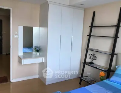 Modern bedroom with sleek wardrobe and stylish shelving unit