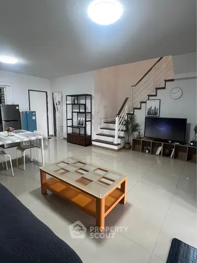 Spacious living room with modern decor and open dining area