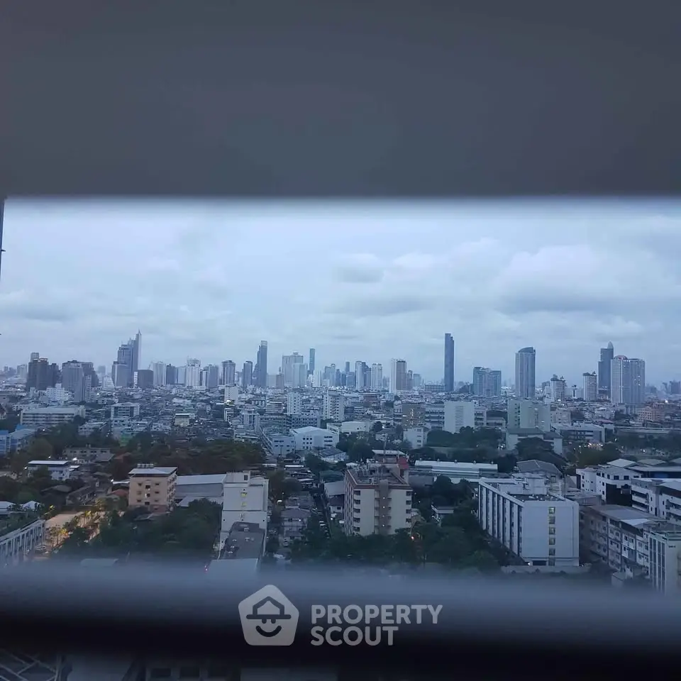 Stunning cityscape view from a high-rise building window, showcasing urban skyline and vibrant city life.