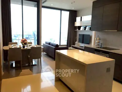 Luxurious open-plan kitchen and living area with city view, perfect for modern living.