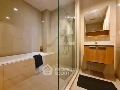 Modern bathroom with bathtub and glass shower enclosure