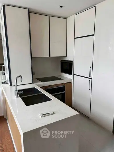 Modern kitchen with sleek cabinetry and built-in appliances