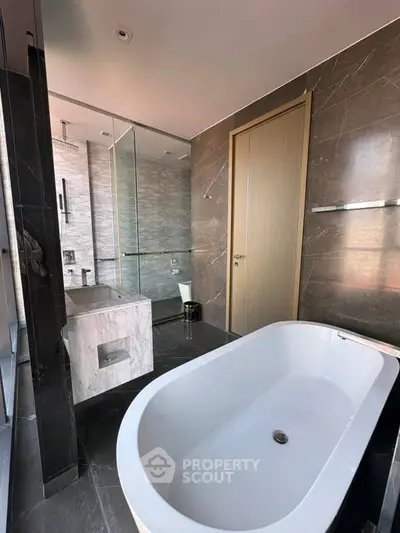 Luxurious modern bathroom with elegant marble finishes and a sleek bathtub.