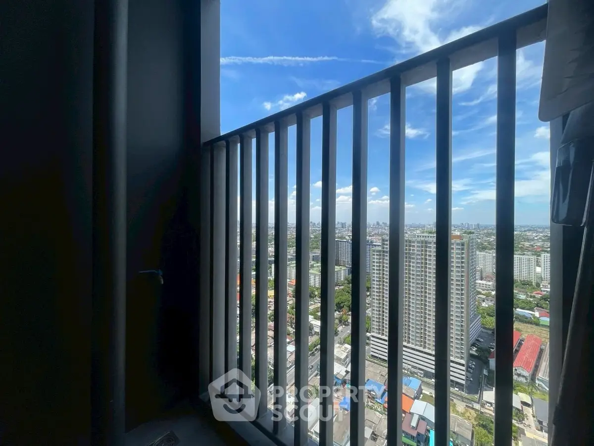 Stunning high-rise balcony view showcasing cityscape and blue sky.