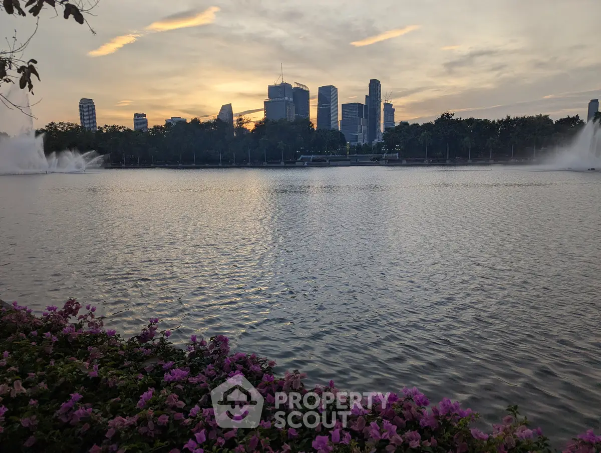 Stunning city skyline view over tranquil lake at sunset, ideal for urban living enthusiasts.