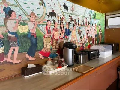 Charming kitchen corner with traditional mural and modern appliances, blending cultural art with contemporary living.