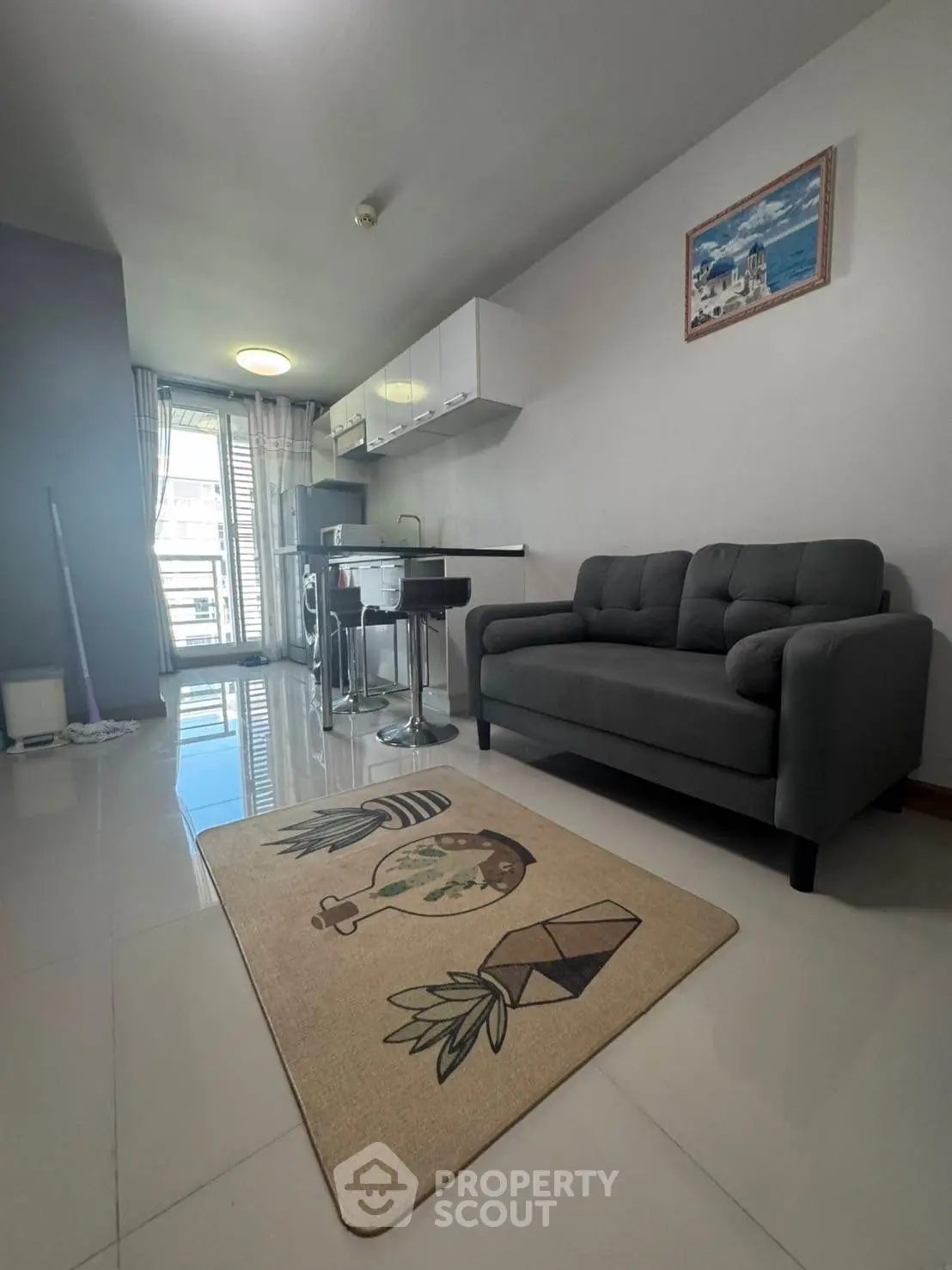 Modern living room with sleek furniture and balcony view in stylish apartment.