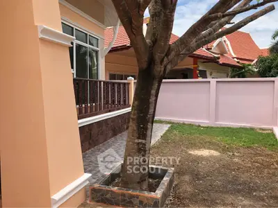 Charming suburban home with spacious yard and mature tree, perfect for family living.