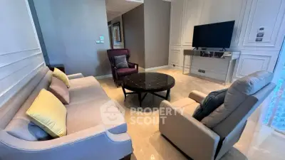 Elegant living room with modern furniture and large TV, perfect for relaxation and entertainment.