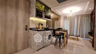 Luxurious modern kitchen with marble finishes and integrated appliances in stylish apartment.