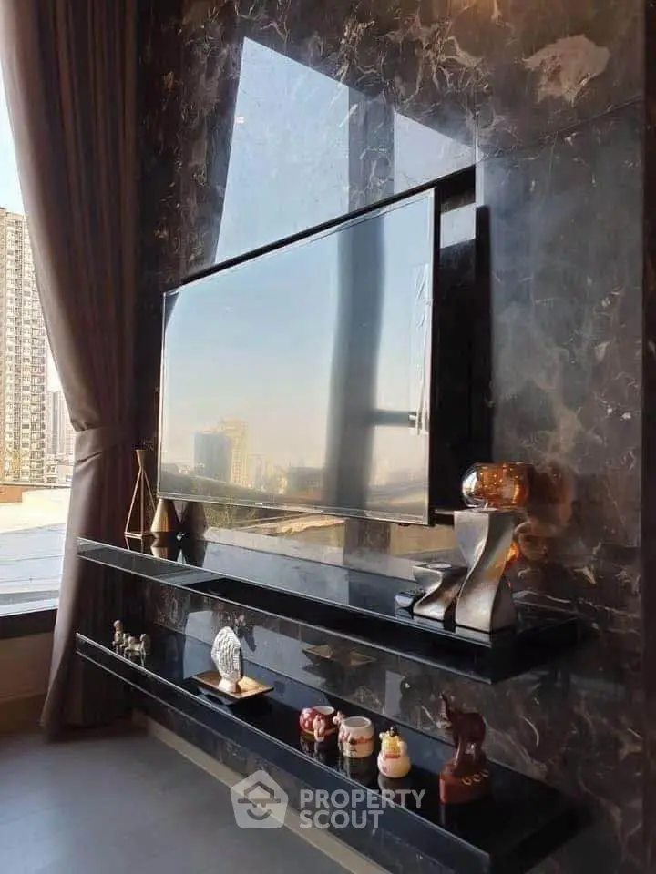 Luxurious living room with marble wall and sleek TV setup, offering a stunning city view.