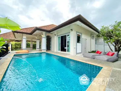 Luxurious villa with private pool and stylish outdoor seating in tropical setting.