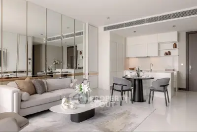 Luxurious modern living room with open kitchen, elegant decor, and cozy seating area.