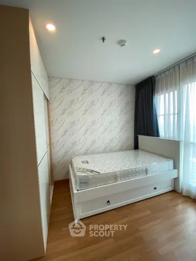 Cozy bedroom with natural light and modern design in real estate property