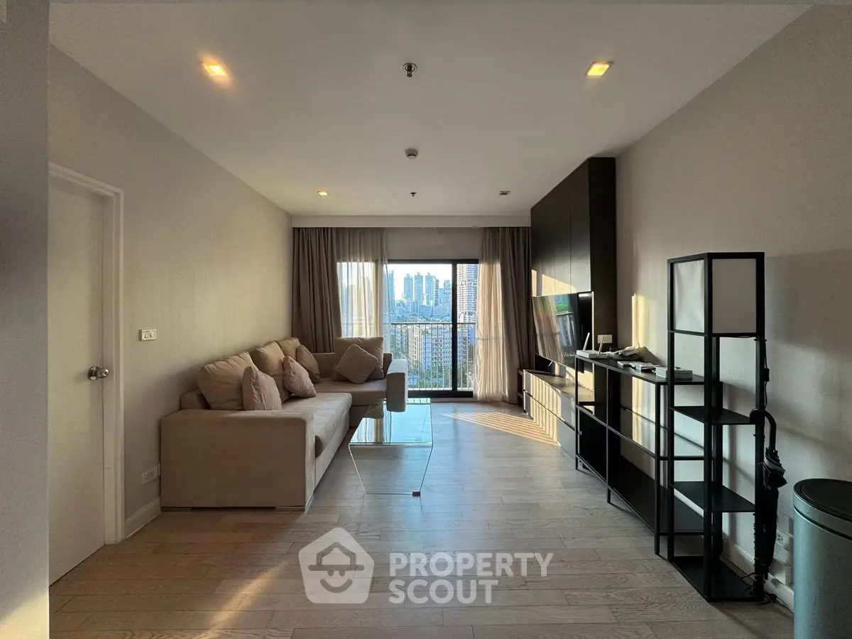 Spacious living room with modern decor and city view from balcony