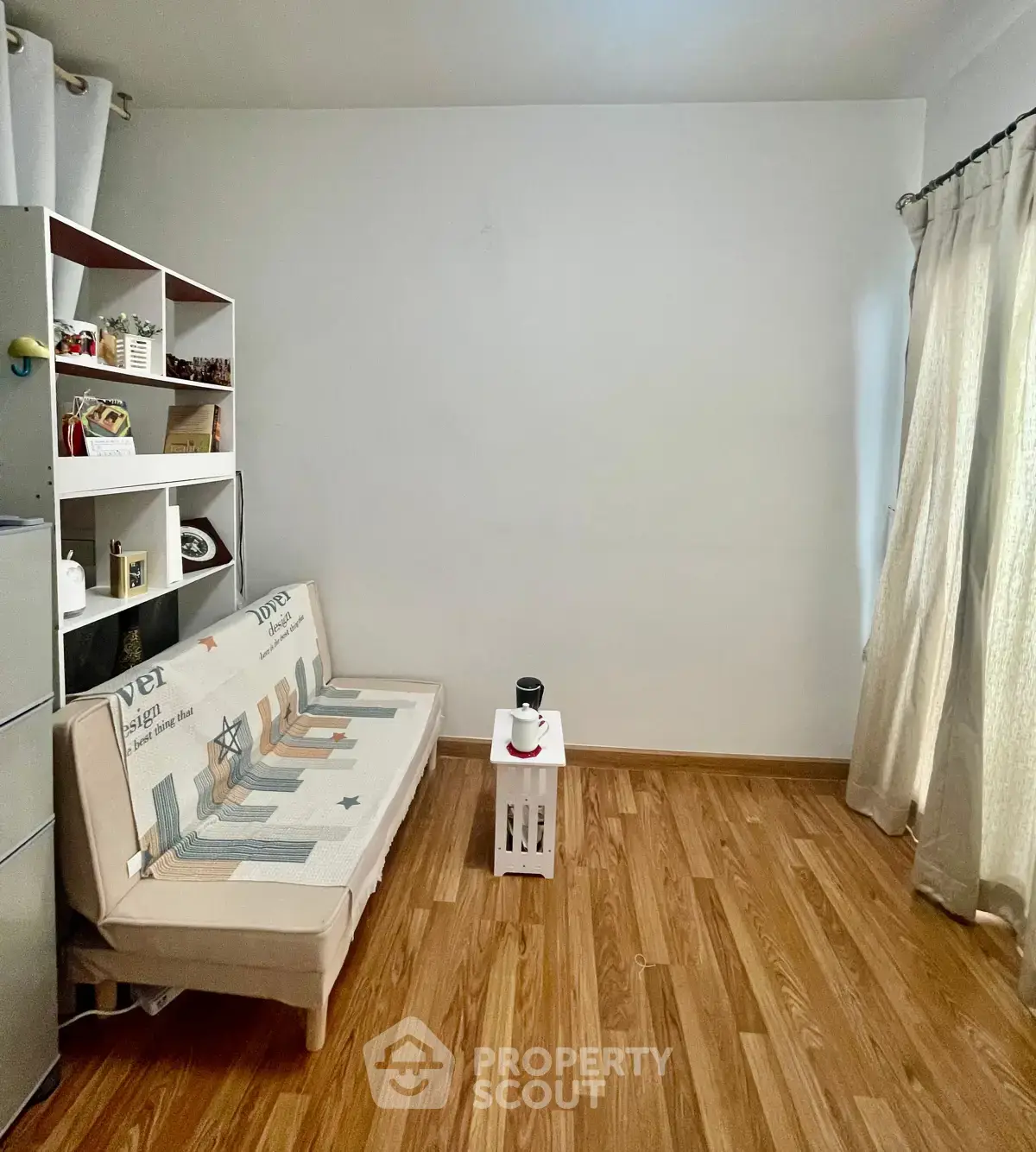 Cozy minimalist living room with wooden flooring and natural light