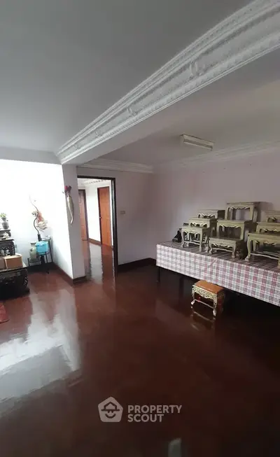 Spacious interior with polished wooden floors and decorative molding