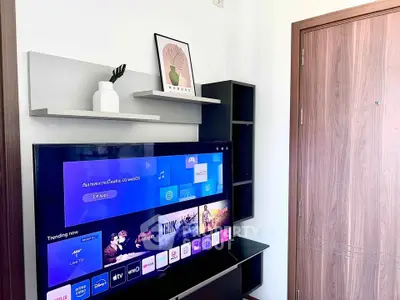 Modern living room with sleek TV setup and stylish shelving, perfect for entertainment and relaxation.