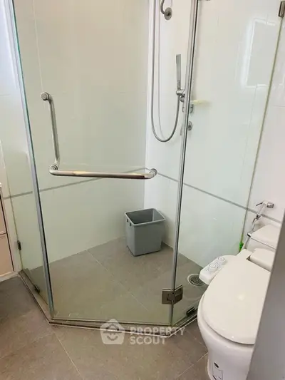 Modern bathroom with glass shower and sleek fixtures in a contemporary home.