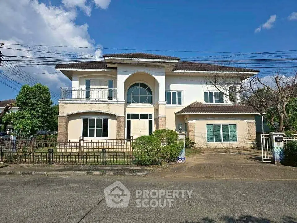 Stunning two-story house with spacious driveway and lush greenery